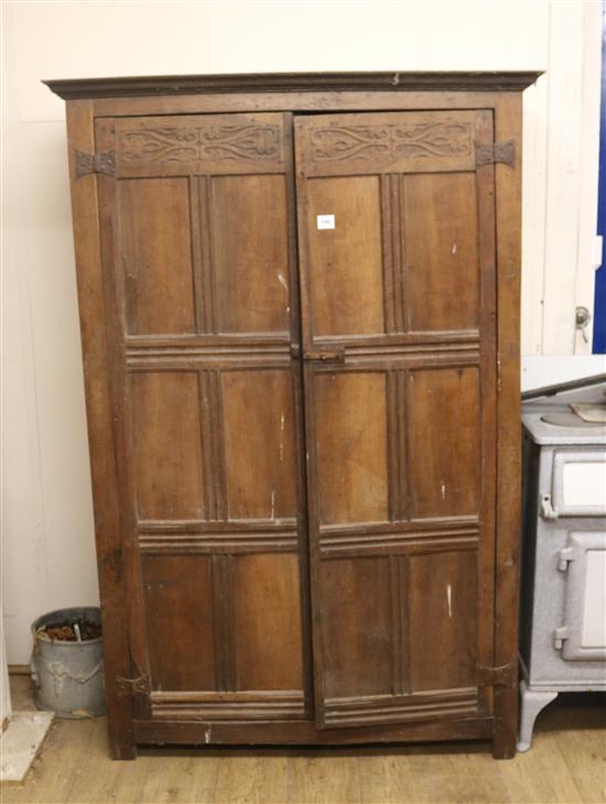 A panelled oak cupboard, H.184cm